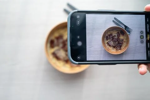 Shoot first eat later concept, shooting truffle white sauce pasta top view. S Stock Photos