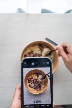 Shoot first eat later concept, shooting truffle white sauce pasta top view. S Stock Photos