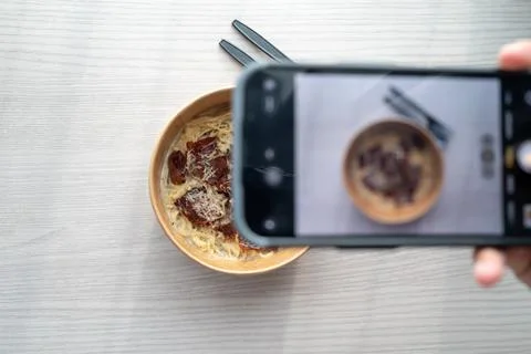 Shoot first eat later concept, shooting truffle white sauce pasta top view. S Stock Photos