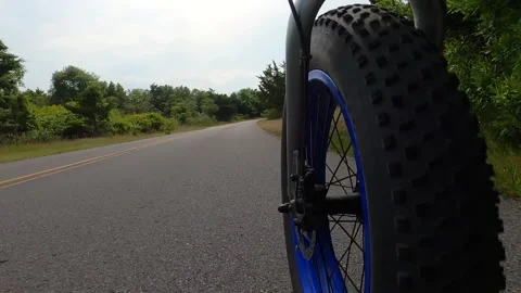 Shoot of the front wheel of an electric bicycle at speed Stock Footage 300057333