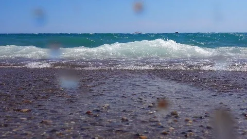 Shoot from a low angle. Sea surf close-up. The wave rushes to the camera. The Stock-Footage 93155795