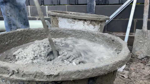 Shoot of mixing concrete using an electric mixer. The worker mixes the mortar 스톡 동영상 223407654