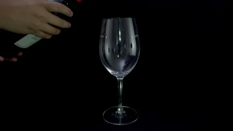 Shoot serving of Red wine glass over a black background Stock Footage 96606887
