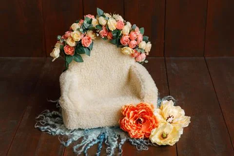 Shoot set up with sofa and a lot of flowers on the wood background. Stock Photos