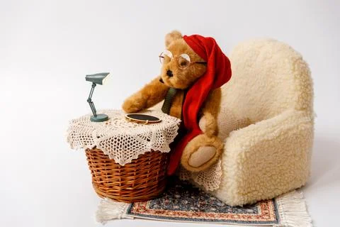 Shoot set up with sofa, table and toy bear with hat and glasses Stock Photos