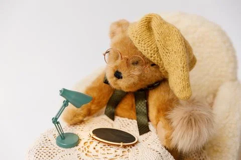 Shoot set up with sofa, table and toy bear with hat and glasses Stock Photos