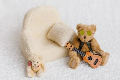 Shoot set up with sofa, teddy bear and guitar Stock Photos