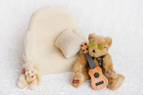 Shoot set up with sofa, teddy bear and guitar Stock Photos