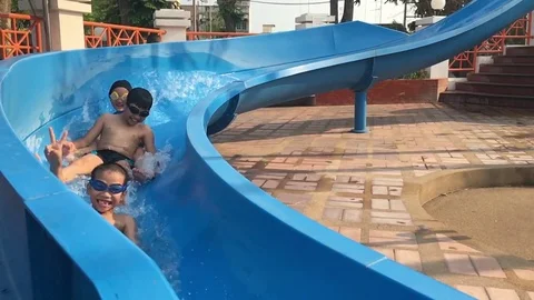 Shoot from smartphone, Slow motion of young Asian Thai boy play in the slider. Stock Footage 73561002