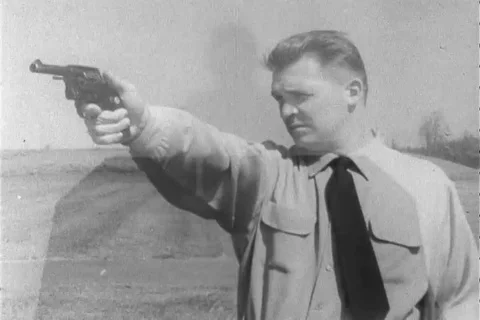 Shooter aim with revolver while target training - 1960 Stock Footage 106067948