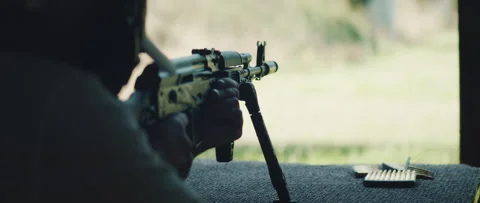 Shooter aims rifle during practice session at outdoor range Video stock 313733992