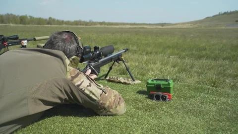 Shooter performs the exercise competitions in high-precision shooting Stock Footage 243798242