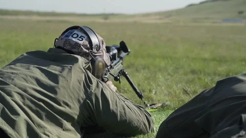 Shooter performs the exercise competitions in high-precision shooting Stock Footage 243908809