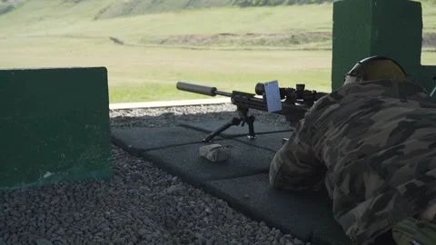 Shooter performs the exercise competitions in high-precision shooting Stock Footage 243908898