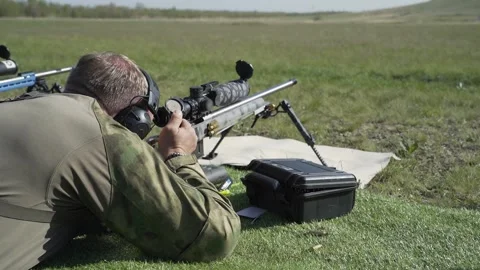 Shooter performs the exercise competitions in high-precision shooting Stock Footage 243908968
