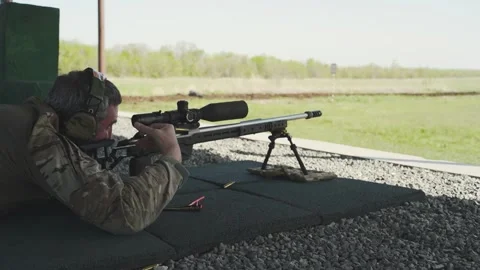 Shooter performs the exercise competitions in high-precision shooting Stock Footage 244042925