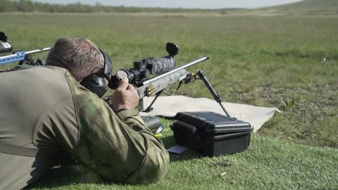 Shooter performs the exercise competitions in high-precision shooting Stock Footage 244042941