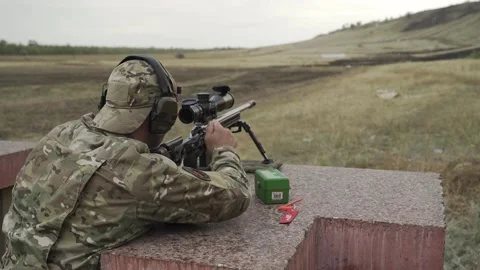 The shooter performs exercises on targets in a sitting position Video stock 250342145