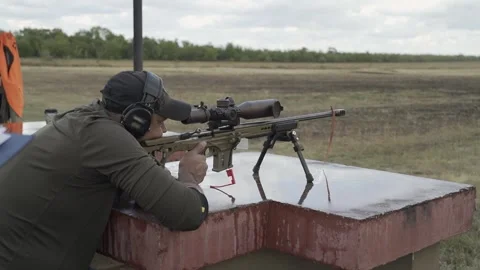 The shooter is preparing to shoot at competitions in a sitting position Stock Footage 251293345