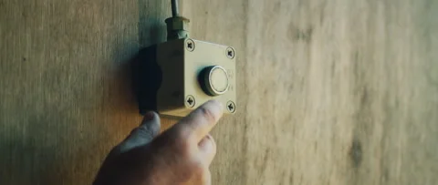 Shooter presses button on wall to control target system during shooting session Stock Footage 309574631
