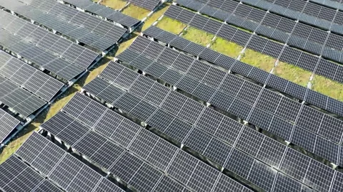 Shooting from above from a drone many solar panels installed on office buildings Video stock 244806549