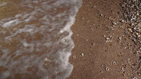 Shooting from above as the waves on the sand on the beach Stock Footage 160954633