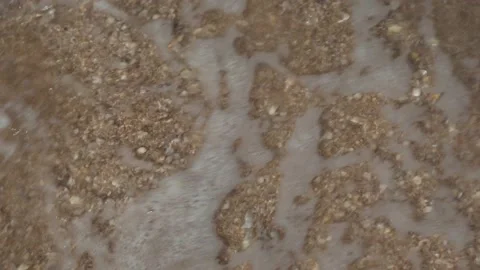 Shooting from above as the waves on the sand on the beach Stock Footage 160954641