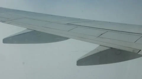 Shooting an airplane wing in small clouds at high altitude Stock Footage 200486073