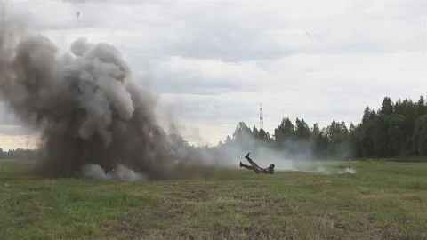 Shooting and explosions. An armed man gets under mortar fire. War Stock Footage 76963717