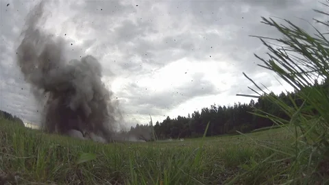 Shooting and explosions. War. An armed man gets under mortar fire. Slow motion Stock Footage 77005958