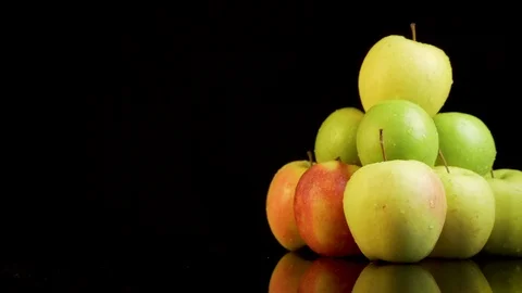 Shooting around a bunch of apples on a black background Stock Footage 113054848