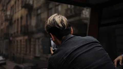 Shooting from the back young man take photo stand in tram use phone transport Stock Footage 98149044