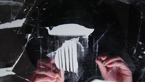 Shooting from below through a transparent table hand holds a credit card cutting Stock Footage 261185155