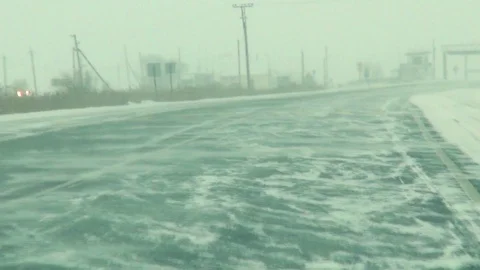 Shooting from the cab when driving on a winter road in Siberia, in snowy weather Stock Footage 87284899