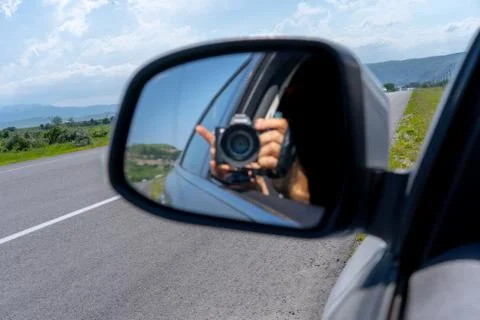 Shooting with the camera from the side window of a car Stock Photos