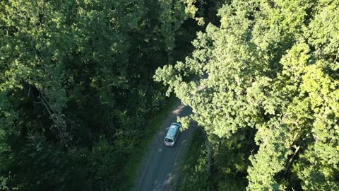 Shooting a car on a narrow road in the middle of the forest. . Drone footage of Stock Footage 288040764