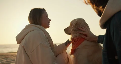 Shooting up close: a guy and a blonde girl are stroking a light-colored soy dog Stock Footage 243492738