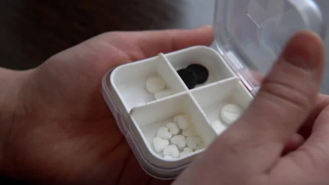 Shooting close-up, hands open a box of pills. Taking your daily pills at home Video stock 150036715