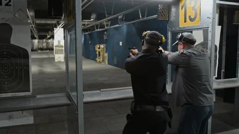 Shooting Coach Teaching Security Officer to Aim Gun and Pull Trigger Video stock 305280185