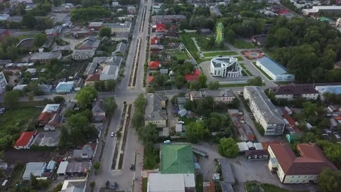 Shooting from a drone flying over a small town flat streets and a ferris wheel Video stock 132646551