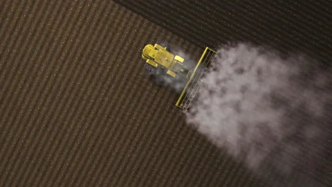 Shooting from drone flying over tractor with harrow system plowing ground on cul Stock Footage 154862954