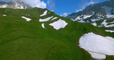 Shooting from the drone of a mountain pass in the Caucasus with green grass and  Видео 83764179
