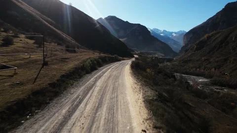 Shooting from a drone of a mountainous area, the camera flies over the road Stock Footage 171299092