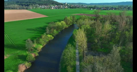 Shooting from a drone . River. Spring. Sunny weather. Green grass. Stock Footage 322679772