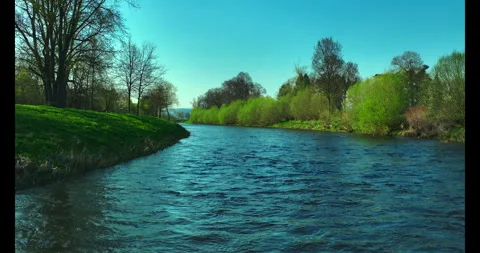 Shooting from a drone . River. Spring. Sunny weather. Green grass. Stock Footage 322684704