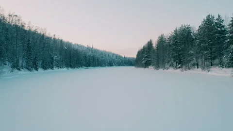 Shooting on a drone. Slow flight at low altitude over a frozen river. Winter. Stock Footage 233768278