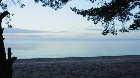 Shooting from a drone at sunset over calm water. Video stock 165520796