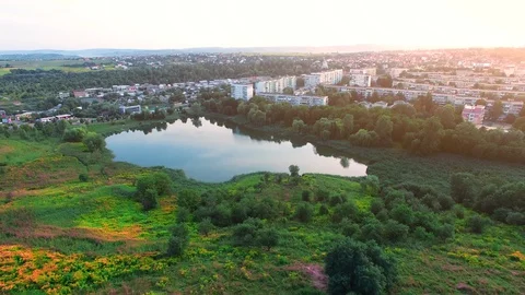 Shooting from a drone where in the frame we see a lake and city Stock Footage 128277589
