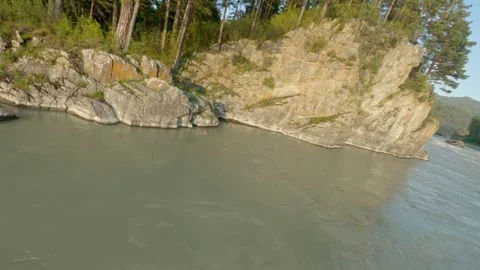 Shooting from a dynamic FPV drone. A flight over a bubbling mountain river with Stock Footage 278365690