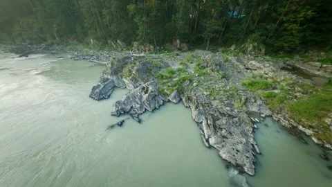 Shooting from a dynamic FPV drone. A flight over a bubbling mountain river with Stock-Footage 278366189